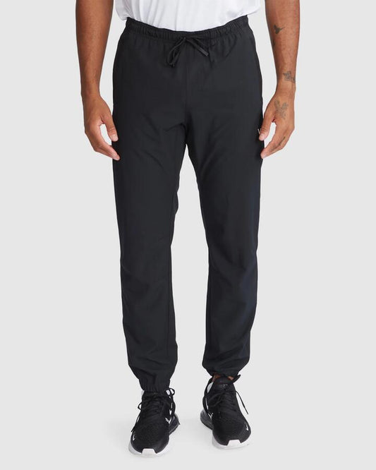 Image of a model wearing Pants. Product name - RVCA Mens Yogger Ii Track Pants Black in Black colour by brand - RVCA