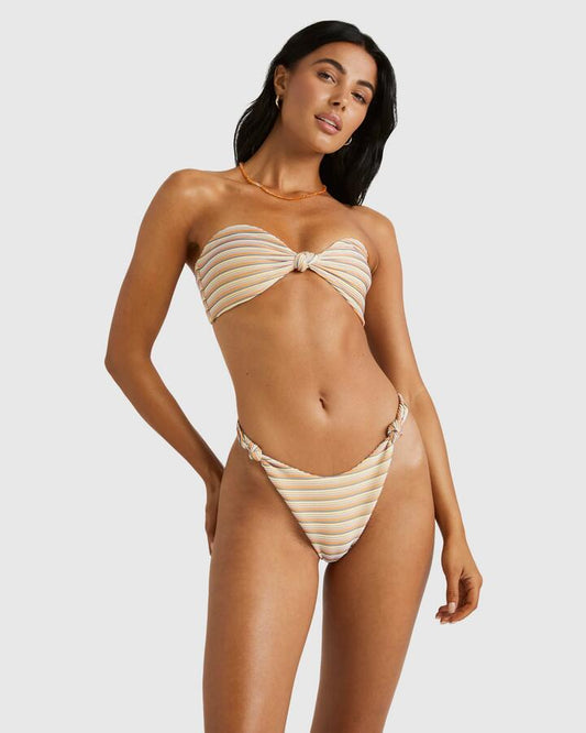 Image of a model wearing Tops. Productname: RVCA Womens Ripple And Twist Bandeau Bikini Top Sunrise - in Sunrise colour by brand - RVCA