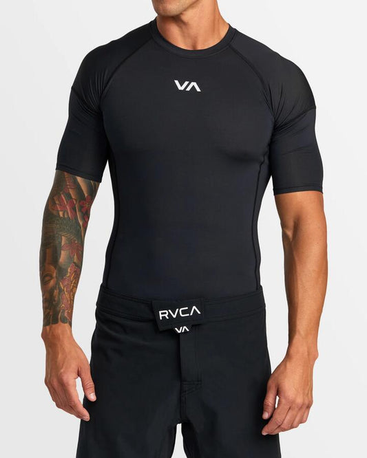 Image of a model wearing Tops. Productname: RVCA - Mens Sport Short Sleeve Rash Vest - Black - in Black colour by brand - RVCA