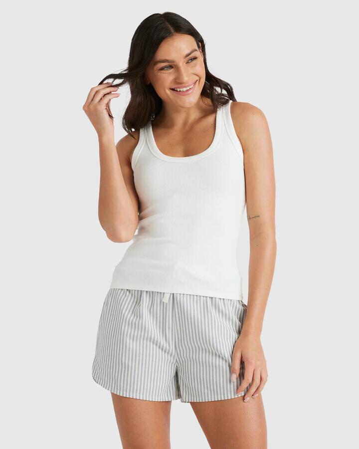Image of a model wearing Tops. Productname: Nunui - Womens Scoop Action Tank - Summer White - in Summer White colour by brand - Nunui