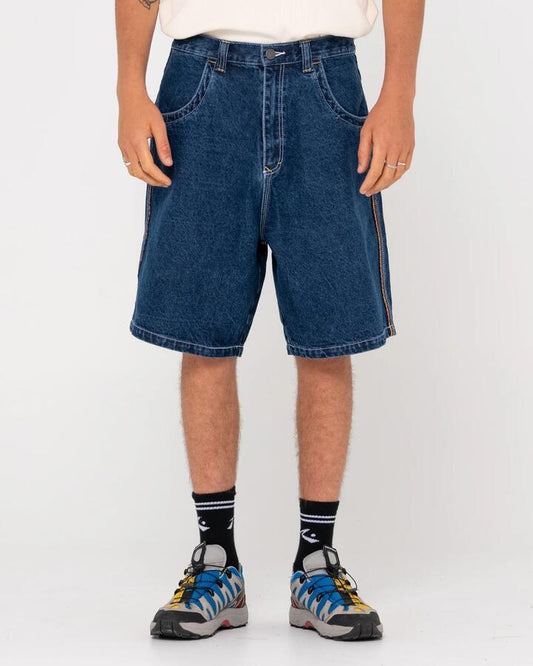 Image of a model wearing Shorts. Productname: Rusty Mens Flip Daddy 2.0 Denim Shorts Deep Sea Blue / Red - in Deep Sea Blue / Red colour by brand - Rusty