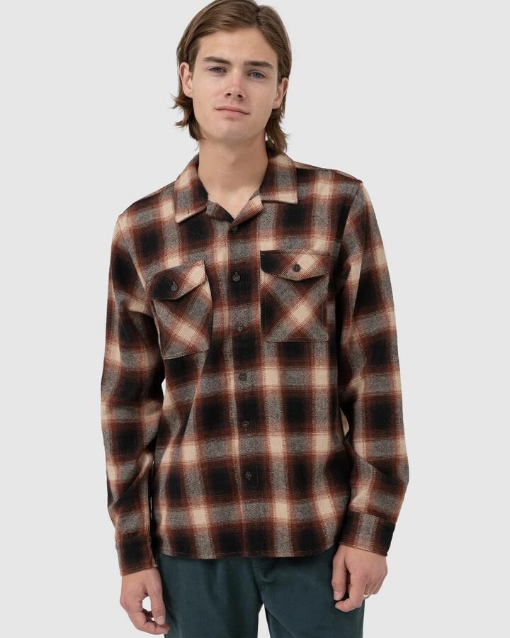 Image of a model wearing Tops. Product name - Rhythm Mens Plaid Long Sleeve Shirt Rust in Rust colour by brand - Rhythm