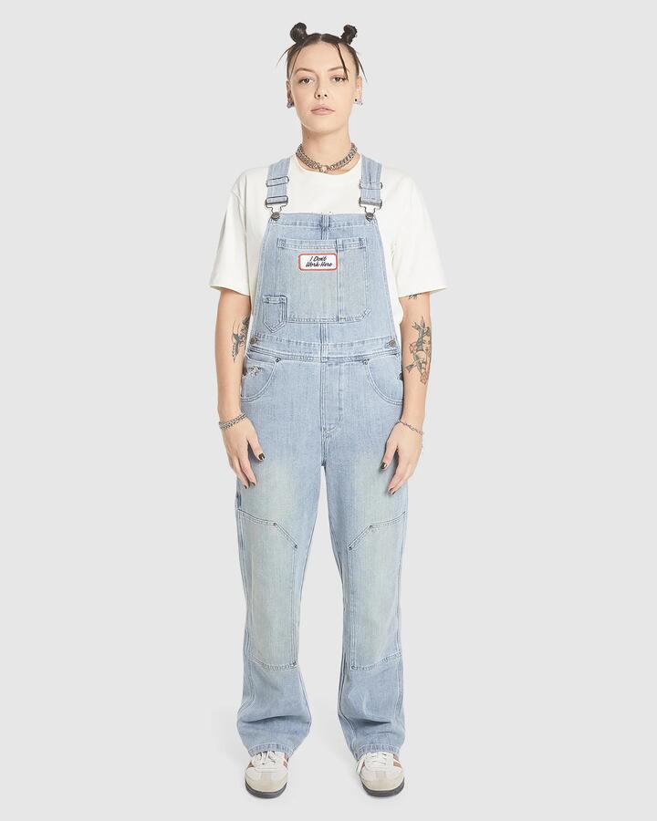 Image of a model wearing Pants. Product name - Worship Womens Double Knee Denim Jumpsuit Overalls Dirty Trade Blue in Dirty Trade Blue colour by brand - Worship