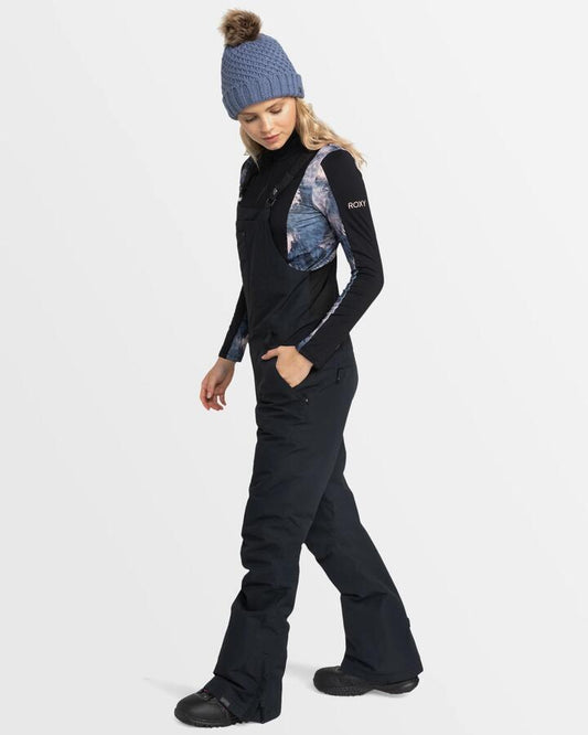 Image of a model wearing Pants. Product name - Roxy Womens Rideout Bib Snow Pants True Black in True Black colour by brand - Roxy