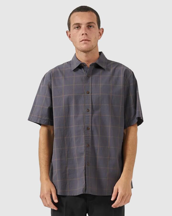 Image of a model wearing Tops. Productname: Thrills - Mens Rise Above Short Sleeve Shirt - Ebony - in Ebony colour by brand - Thrills
