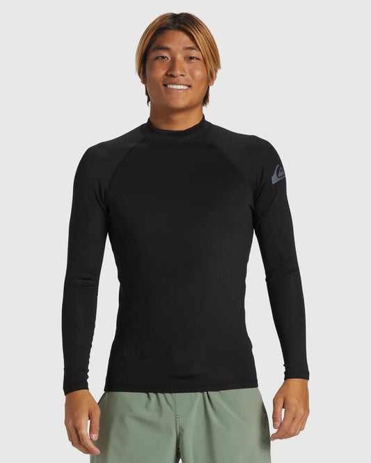 Image of a model wearing Tops. Productname: Quiksilver - Mens Everyday Heat Long Sleeve Upf 50 Rash Vest - Black - in Black colour by brand - Quiksilver