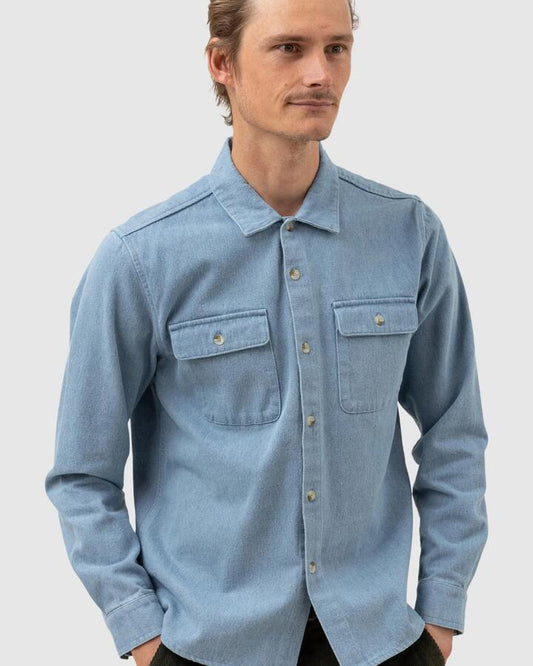 Image of a model wearing Tops. Productname: Rhythm - Mens Denim Long Sleeve Shirt - Denim - in Denim colour by brand - Rhythm