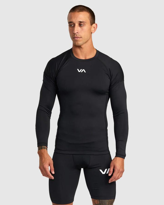 Image of a model wearing Tops. Product name - RVCA Mens Compression Long Sleeve T-Shirt Black in Black colour by brand - RVCA