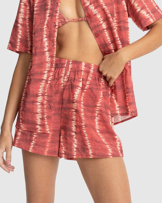 Image of a model wearing Shorts. Productname: Rhythm - Womens Sahara Tie Dye Beach Shorts - Red - in Red colour by brand - Rhythm