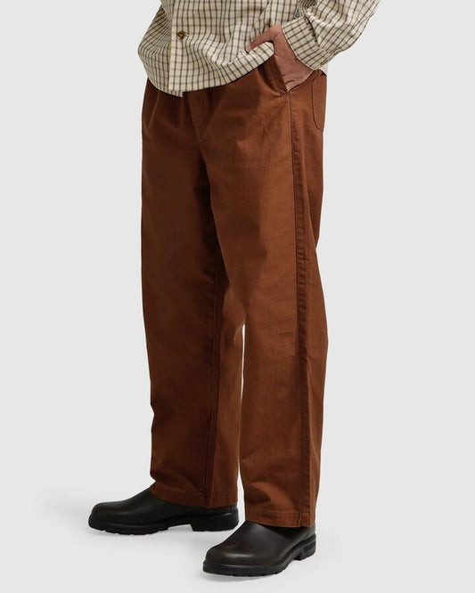 Image of a model wearing Pants. Productname: Rhythm - Mens Slacker Pants - Coffee - in Coffee colour by brand - Rhythm