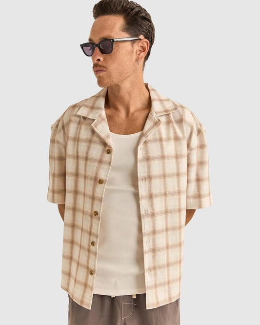 Image of a model wearing Tops. Productname: Rhythm - Mens Relaxed Check Short Sleeve Shirt - Natural - in Natural colour by brand - Rhythm