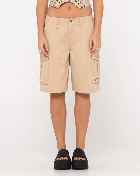 Image of a model wearing Shorts. Product name - Rusty Womens Tank Girl Low Rise Loose Fit Cargo Shorts Oatmilk in Oatmilk colour by brand - Rusty