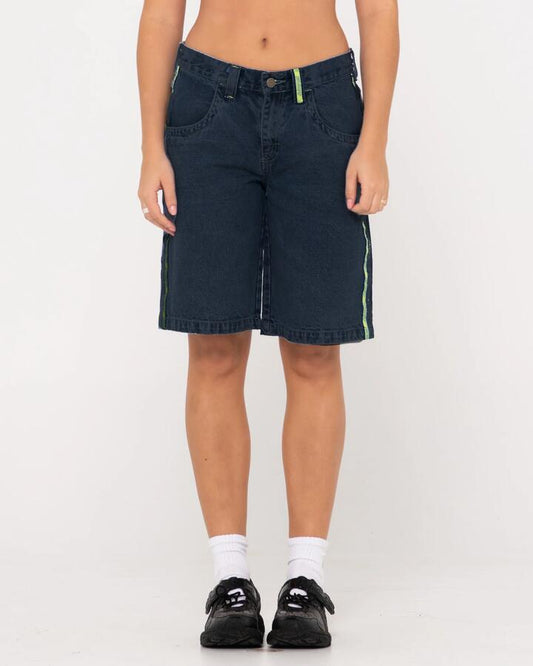 Image of a model wearing Shorts. Productname: Rusty - Womens Flip Mommy Low Rise Wide Leg Denim Shorts - Deep Blue / Lime - in Deep Blue / Lime colour by brand - Rusty