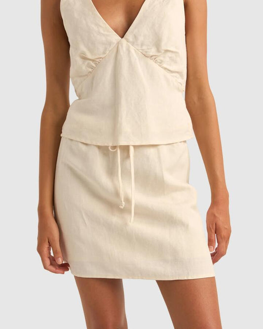 Image of a model wearing Skirts. Productname: Rhythm - Womens Lenny Drawcord Mini Skirt - Cream - in Cream colour by brand - Rhythm