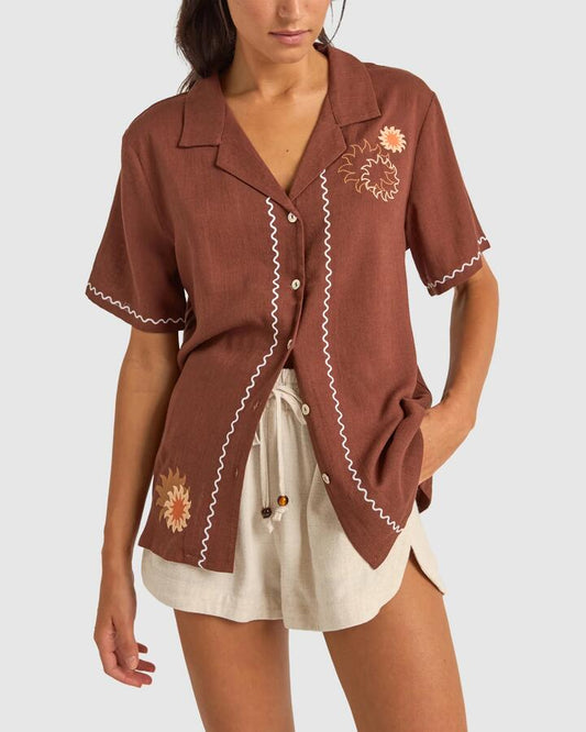 Image of a model wearing Tops. Productname: Rhythm - Womens Solis Embroidered Short Sleeve Shirt - Chocolate - in Chocolate colour by brand - Rhythm
