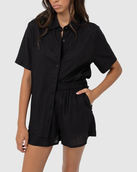 Image of a model wearing Tops. Productname: Rhythm Womens Classic Lounge Short Sleeve Shirt Black - in Black colour by brand - Rhythm