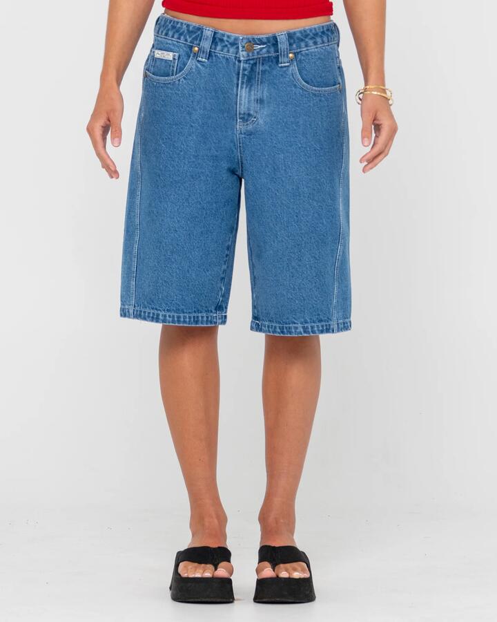 Image of a model wearing Shorts. Productname: Rusty - Womens Legless Low Rise Denim Shorts - Middy Blue - in Middy Blue colour by brand - Rusty