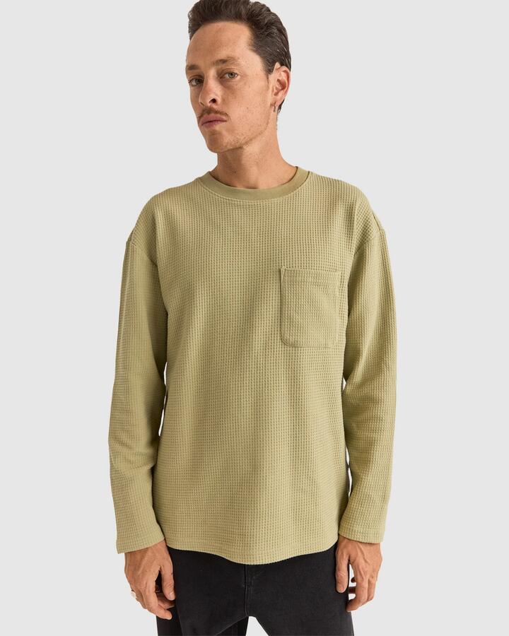 Image of a model wearing Tops. Product name - Rhythm Mens Vintage Waffle Long Sleeve T-Shirt Fatigue in Fatigue colour by brand - Rhythm