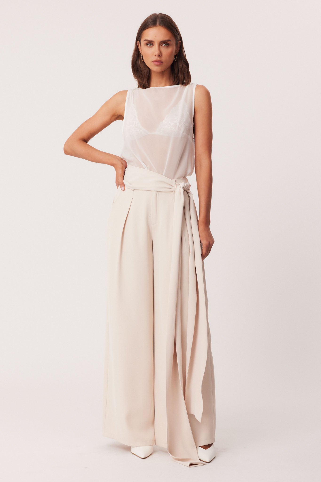 Image of a model wearing Pants. Productname: SNDYS REID PANTS in Stone colour by brand - SNDYS