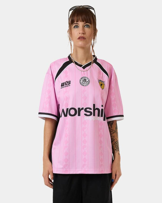 Image of a model wearing Tops. Productname: Worship - Womens Player V Neck Football Jersey - Bubblegum Pink - in Bubblegum Pink colour by brand - Worship
