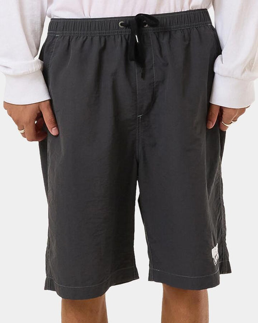 Image of a model wearing Shorts. Productname: Worship - Mens Dry Paint Baggie Nylon Short - Worn Black - in Worn Black colour by brand - Worship