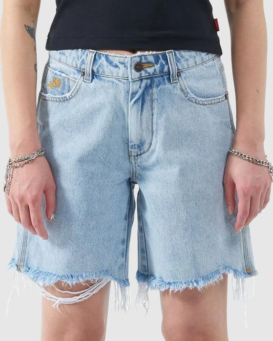 Image of a model wearing Shorts. Productname: Worship - Womens Damage Stubby Shorts - Worship Worn Blue - in Worship Worn Blue colour by brand - Worship