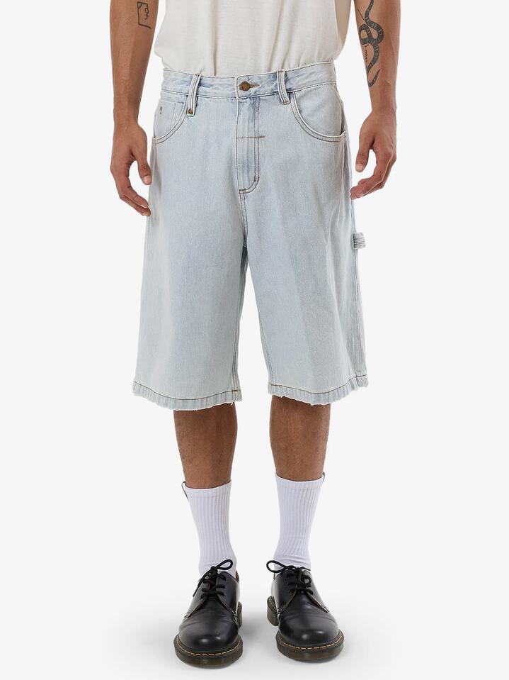 Image of a model wearing Shorts. Product name - Thrills Mens Big Slacker Denim Shorts Dirty Fade in Dirty Fade colour by brand - Thrills