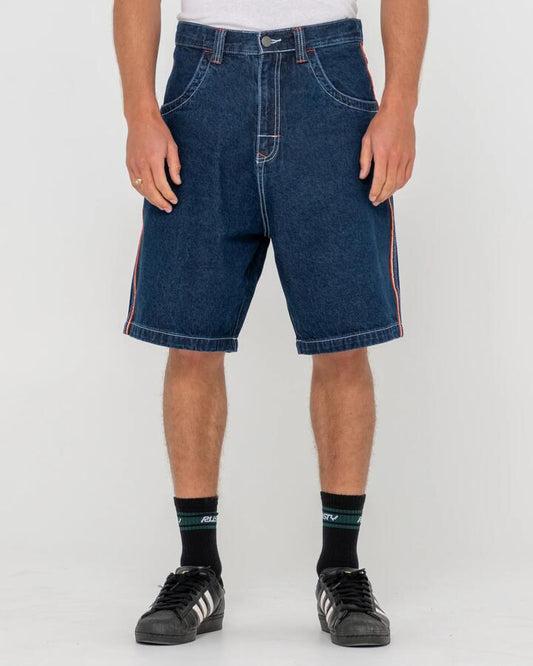 Image of a model wearing Shorts. Productname: Rusty - Mens Flip Daddy 2.0 Denim Shorts - Deep Sea Blue / Oran - in Deep Sea Blue / Oran colour by brand - Rusty