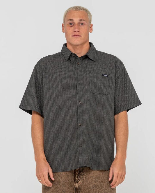 Image of a model wearing Tops. Productname: Rusty - Mens Resno Check Short Sleeve Shirt - Black - in Black colour by brand - Rusty