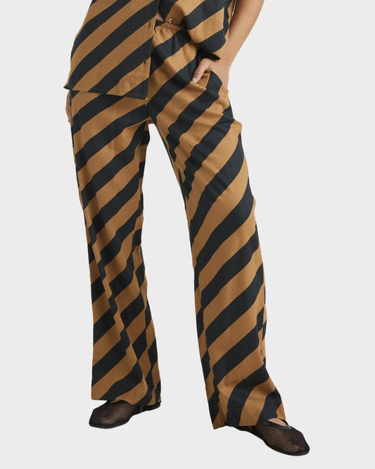 Image of a model wearing Pants. Product name - RVCA Womens Milspec Stripe Holiday Elastic Waist Pants Camel in Camel colour by brand - RVCA