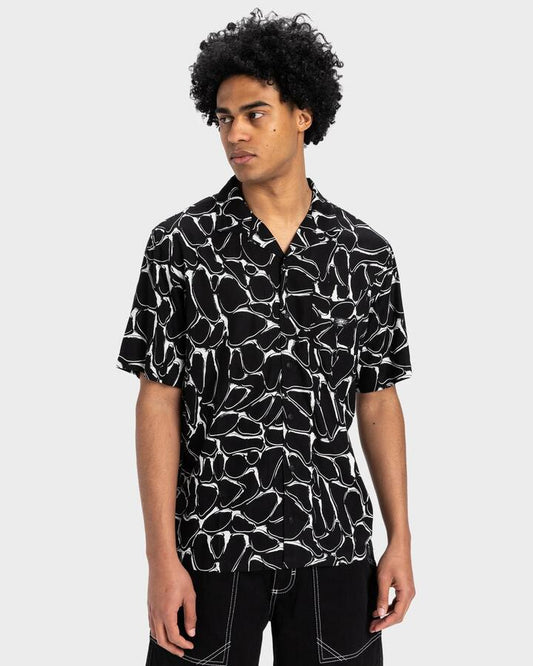 Image of a model wearing Tops. Productname: Quiksilver Mens Mercury Chrome Short Sleeve Shirt Black Mercury Chrome - in Black Mercury Chrome colour by brand - Quiksilver