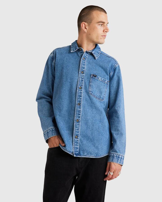 Image of a model wearing Tops. Productname: RVCA Mens Rvca Classics Denim Long Sleeve Top Vintage Blue - in Vintage Blue colour by brand - RVCA