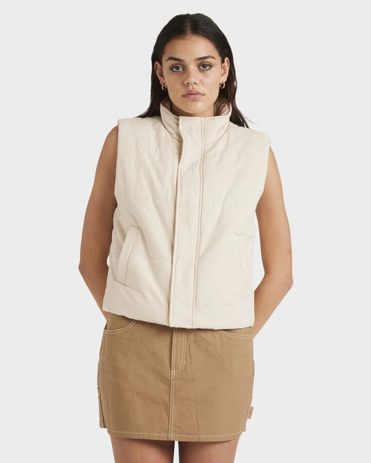 Image of a model wearing Outerwear. Productname: RVCA Womens Eezeh Puffer Vest Salt - in Salt colour by brand - RVCA