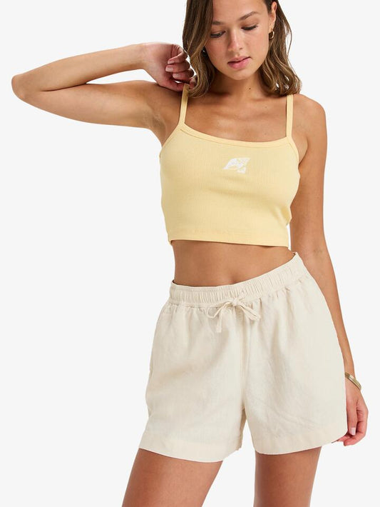 Image of a model wearing Shorts. Product name - Roxy Womens Lekeitio Break Mid Elastic Waist Shorts Parchment in Parchment colour by brand - Roxy