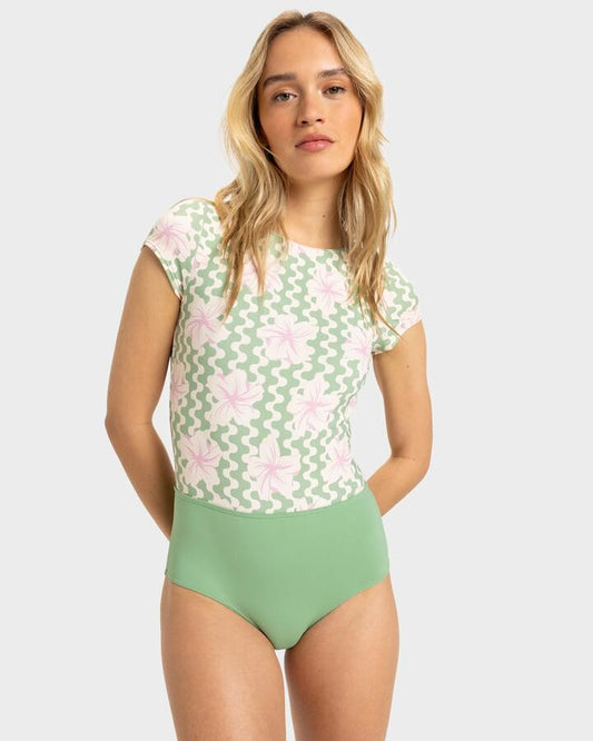 Image of a model wearing Tops. Productname: Roxy Womens Hibiscus Daze Short Sleeve Rash Vest Basil Party Waves Yw - in Basil Party Waves Yw colour by brand - Roxy
