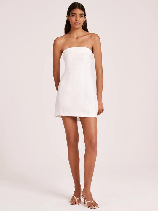 Image of a model wearing Dress. Productname: Nude Lucy Lyra Linen Dress in White colour by brand - Nude Lucy