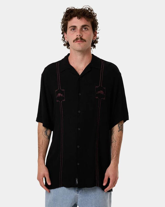 Image of a model wearing Shorts. Productname: Thrills - Mens Still Life Bowling Short Sleve Shirt - Black - in Black colour by brand - Thrills