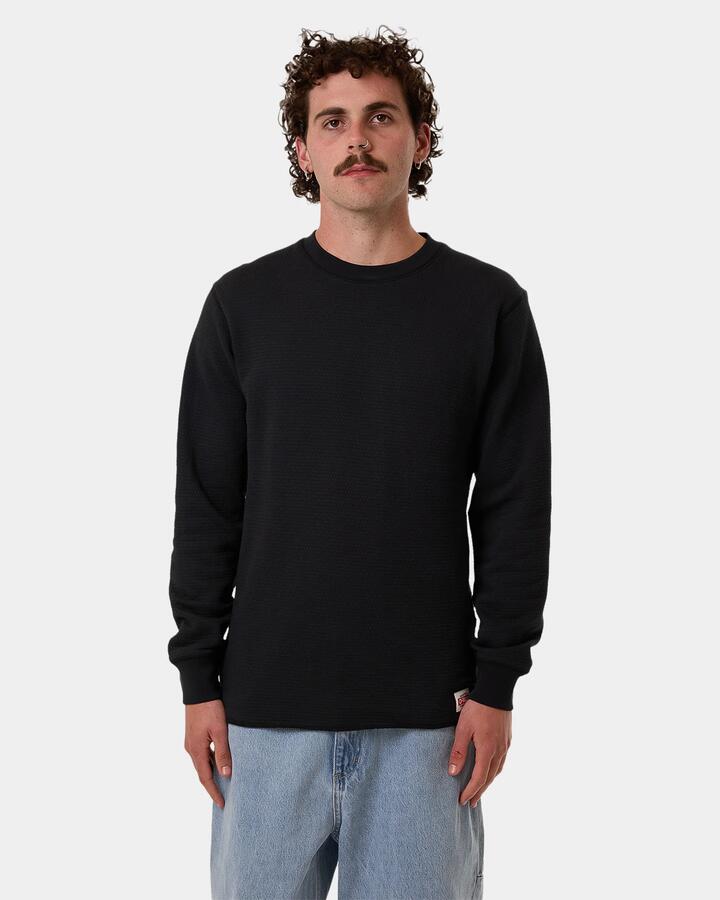 Image of a model wearing Tops. Product name - Thrills Mens Adapted Waffle Long Sleeve T-Shirt Black in Black colour by brand - Thrills