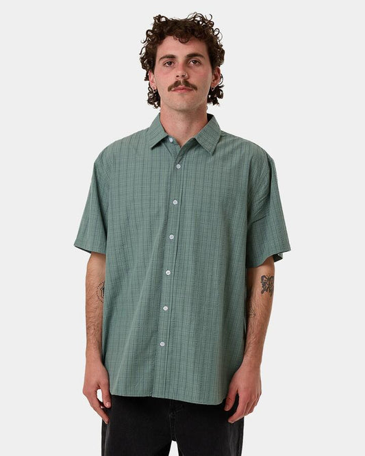 Image of a model wearing Tops. Productname: Thrills - Mens Ambient Connections Short Sleeve Shirt - Chinois Green - in Chinois Green colour by brand - Thrills