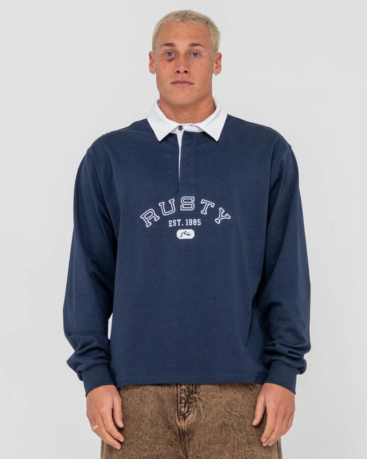 Image of a model wearing Tops. Productname: Rusty - Mens Harvard Rugby Long Sleeve Polo Shirt - Navy Blue - in Navy Blue colour by brand - Rusty