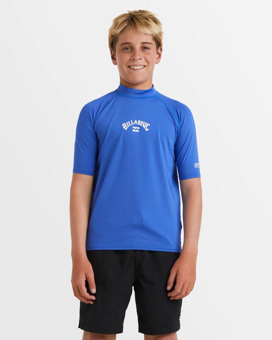 Image of a model wearing Tops. Productname: Billabong Boys 8-16 All Day Arch Short Sleeve Rash Vest Cobalt - in Cobalt colour by brand - Billabong