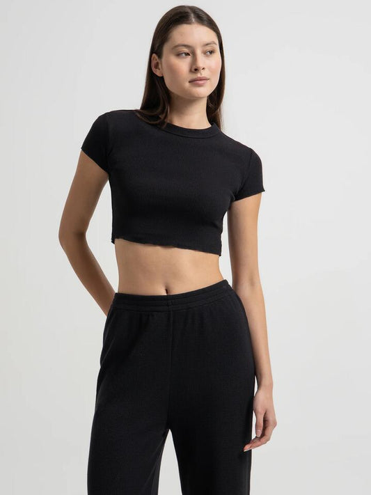 Image of a model wearing Tops. Productname: Nude Lucy Essential Waffle T-Shirt in Black colour by brand - Nude Lucy