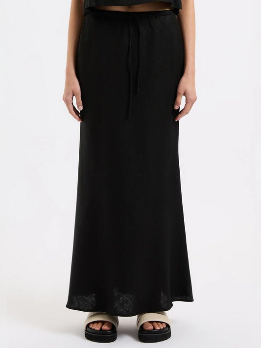 Image of a model wearing Skirts. Productname: Nude Lucy Amani Linen Skirt in Black colour by brand - Nude Lucy