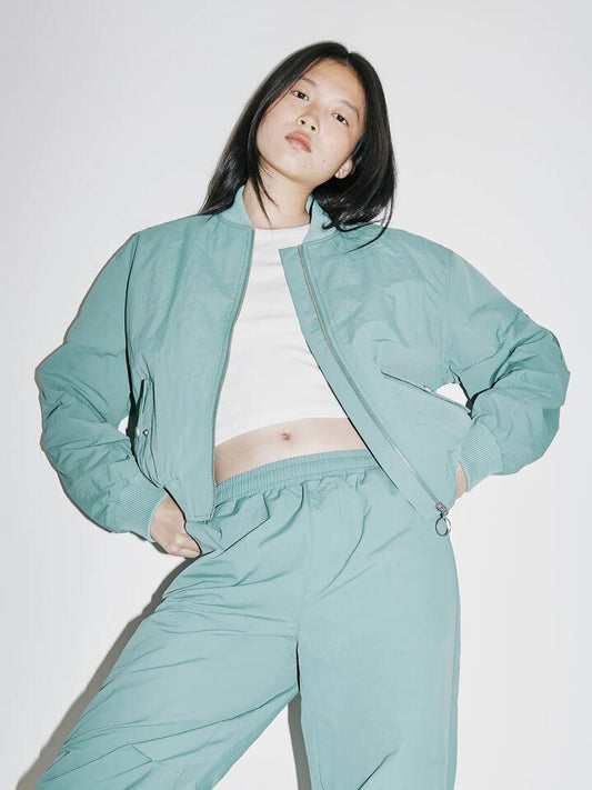 Image of a model wearing Outerwear. Productname: Beyond Her Chicago Bomber Jacket in Pine colour by brand - Beyond Her