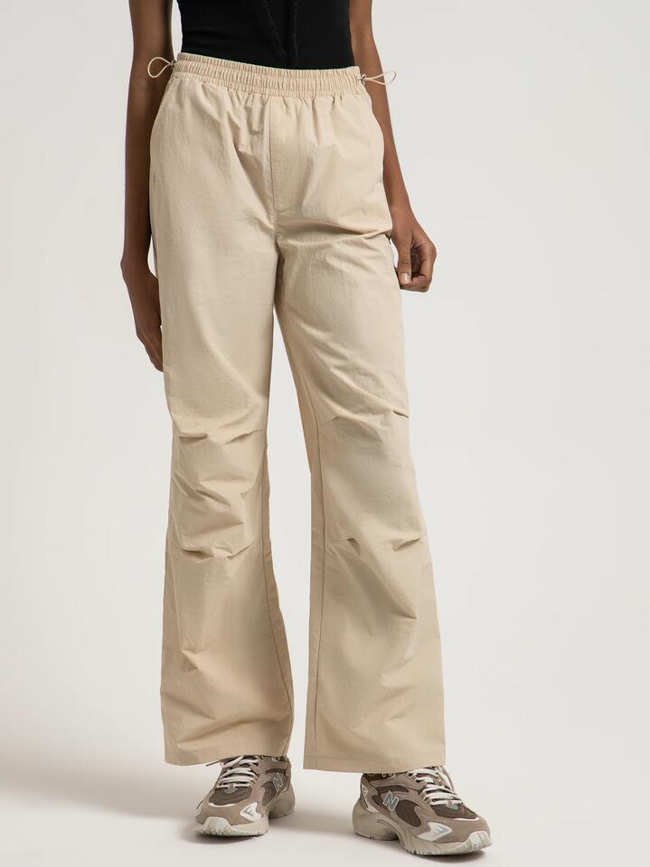 Image of a model wearing Pants. Productname: Beyond Her Chicago Parachute Pants in Bone colour by brand - Beyond Her