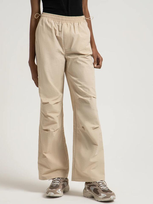 Image of a model wearing Pants. Productname: Beyond Her Chicago Parachute Pants in Bone colour by brand - Beyond Her