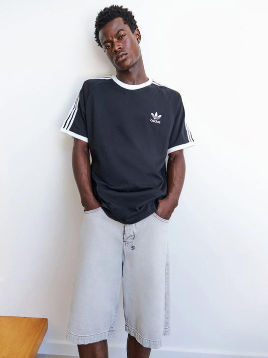 Image of a model wearing Tops. Productname: Adidas Adicolor Classics 3 Stripes T-Shirt in Black colour by brand - Adidas