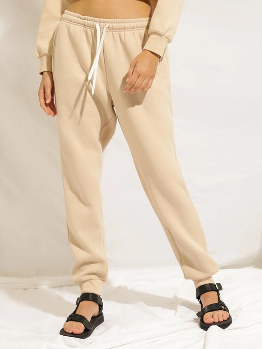 Image of a model wearing Pants. Productname: Nude Lucy Carter Trackpant in Sand colour by brand - Nude Lucy