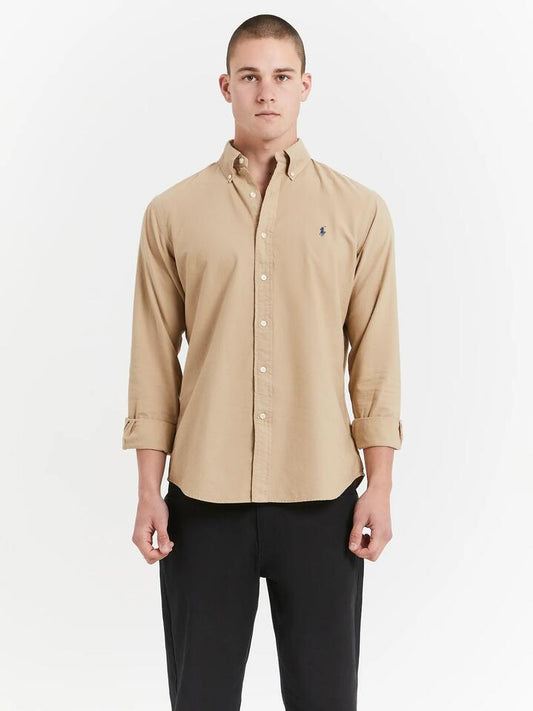 Image of a model wearing Tops. Productname: Polo Ralph Lauren Long Sleeve Button Up Oxford Shirt in Surrey Tan colour by brand - Polo Ralph Lauren