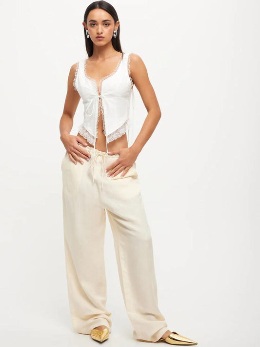 Image of a model wearing Pants. Productname: Lioness La Palma Low-Rise Baggy Pants in Off White colour by brand - Lioness